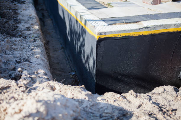 Professional Basement Waterproofing technician working in Norwich, KS